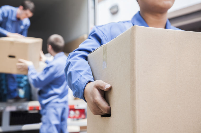 Family moving to Spartanburg, SC carrying moving boxes 