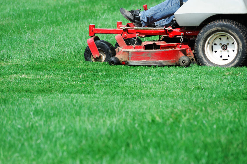 Man on tractor mowing his lawn on a country home in South Carolina 