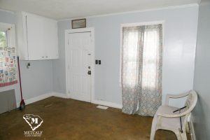 Cozy entryway of a 2 bed, 1 bath home in Inman, featuring a door, window with curtains, and a plastic chair. Cozy entryway of a 2 bed, 1 bath home in Inman, featuring a door, window with curtains, and a plastic chair.