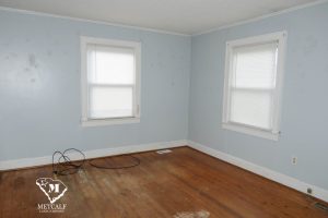 Empty room with light blue walls, two windows, and hardwood floors, showcasing potential for a 2 bed, 1 bath home in Inman. Empty room with light blue walls, two windows, and hardwood floors, showcasing potential for a 2 bed, 1 bath home in Inman.