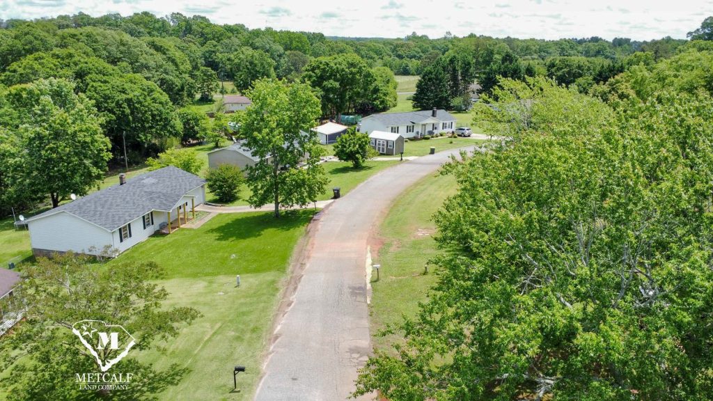 Aerial view of a residential area with multiple homes and greenery, located near Interstate 85.