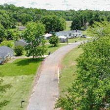 Aerial view of a residential area with multiple homes and greenery, located near Interstate 85.