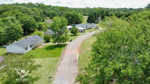 Aerial view of a residential area with multiple homes and greenery, located near Interstate 85. Aerial view of a residential area with multiple homes and greenery, located near Interstate 85.