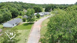 Aerial view of a residential area with homes and greenery, showcasing multi-use property near Interstate 85. Aerial view of a residential area with homes and greenery, showcasing multi-use property near Interstate 85.