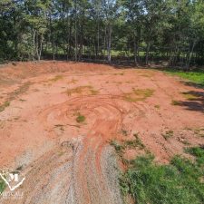 Cleared 2.5-acre homesite in Campobello, surrounded by trees and featuring a dirt path.